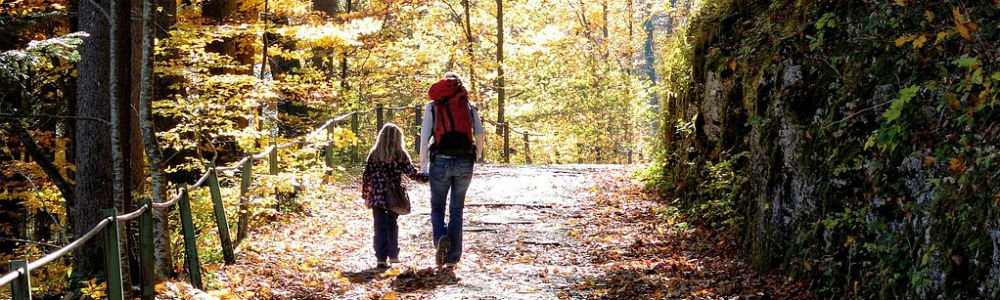 image of mother and daughter walking along a park trail